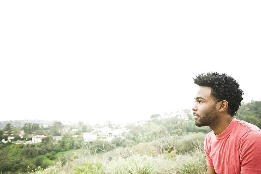African American man sitting on hilltop