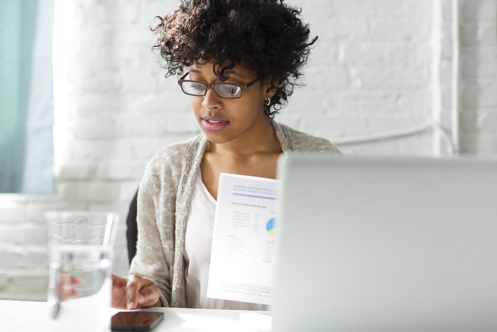 Mixed race architect working at desk