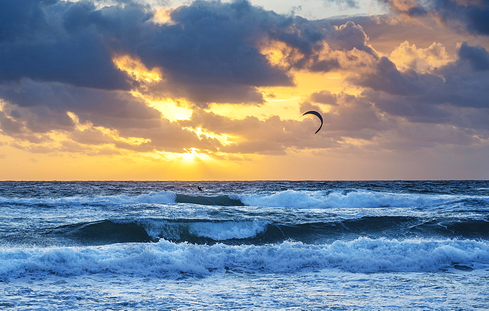 United States, Florida, Delray Beach, Kite surfer in ocean at sunrise