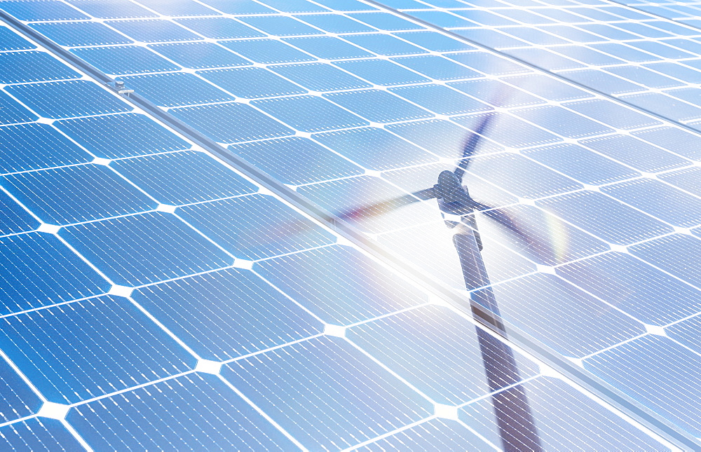 Wind turbine reflected in solar panels