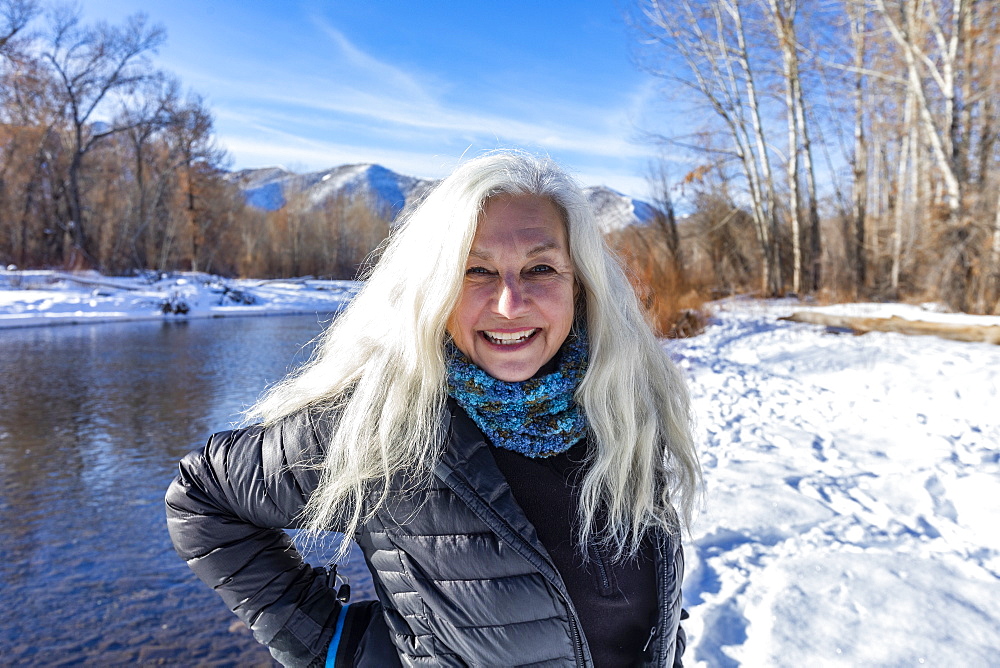 United States, Idaho, Bellevue, Outdoor portrait of smiling senior woman with long white hair in winter landscape