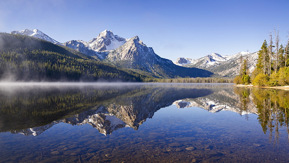 United States, Idaho, Sawtooth Lake surrounded with snowcapped Sawtooth mountains