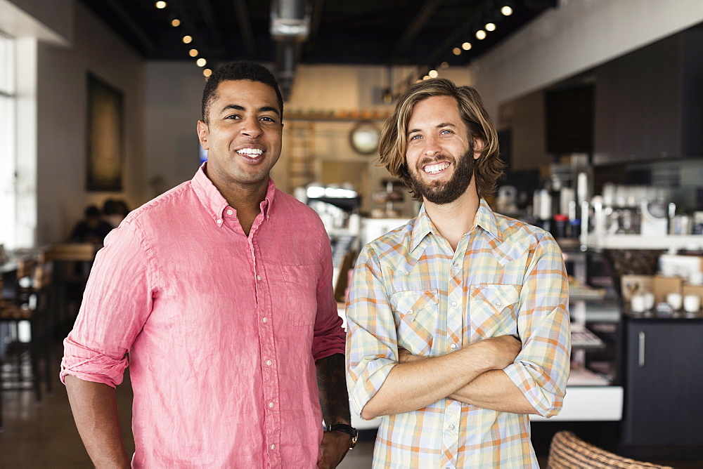 Portrait of two men in coffee shop