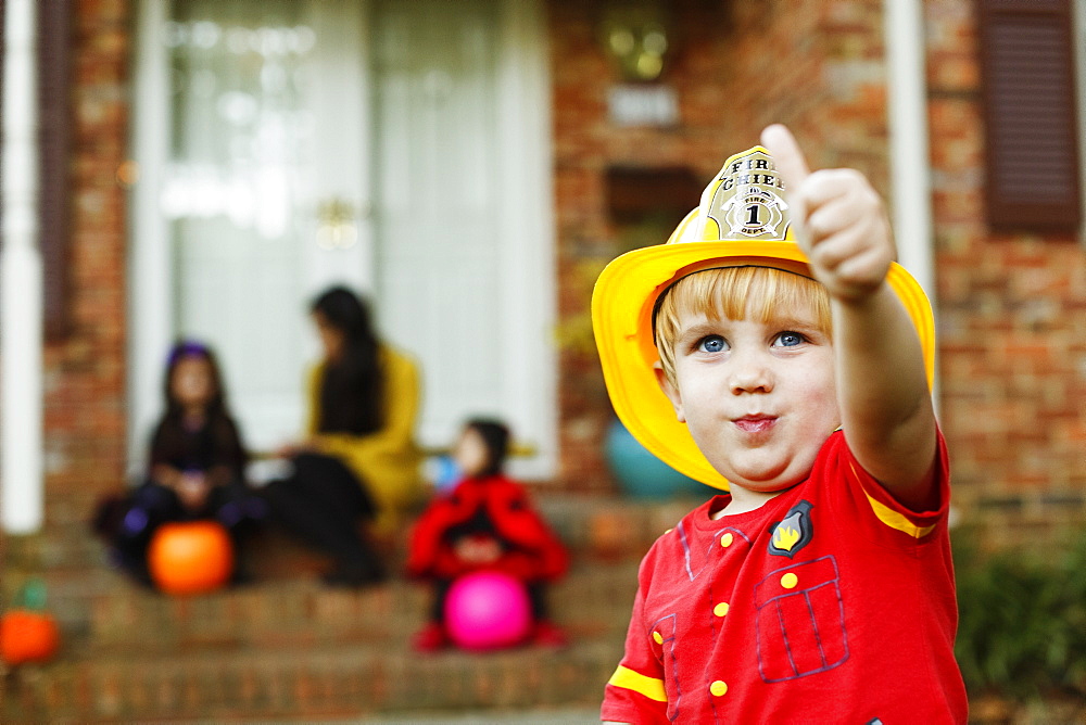 Boy wearing fireman's helmet