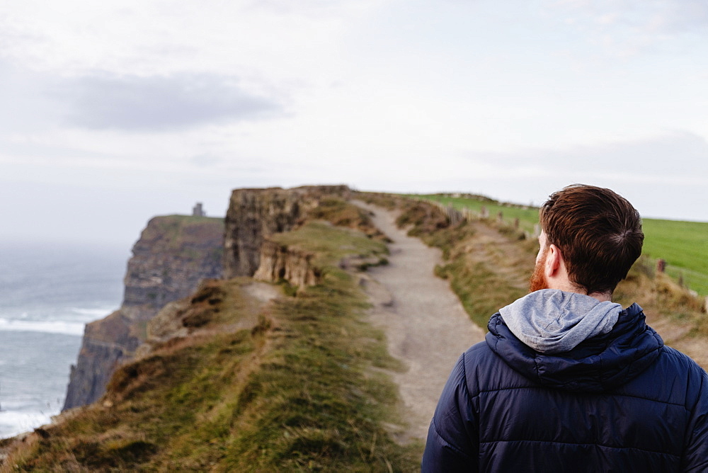 Mid adult man on The Cliffs of Moher, The Burren, County Clare, Ireland