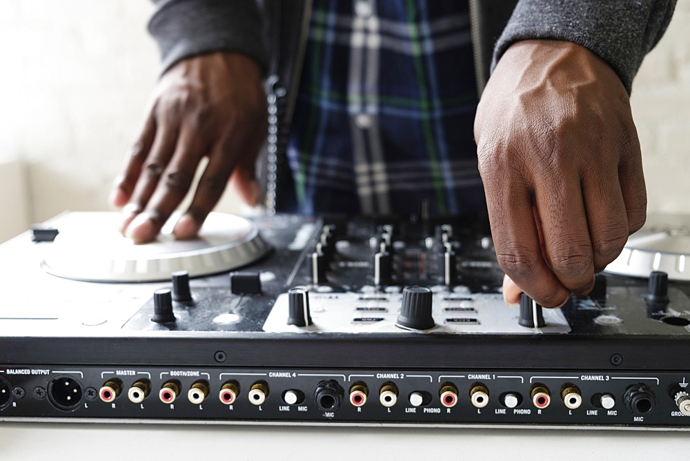 DJ using mixing desk, close up