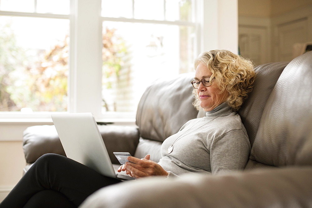 Senior woman shopping online on laptop