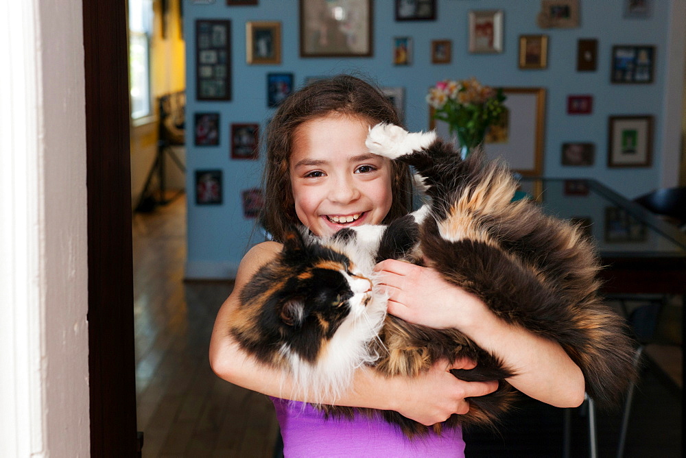 Girl holding pet cat