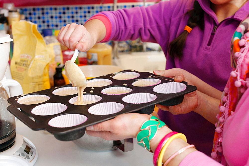 Mother and daughter making cupcakes