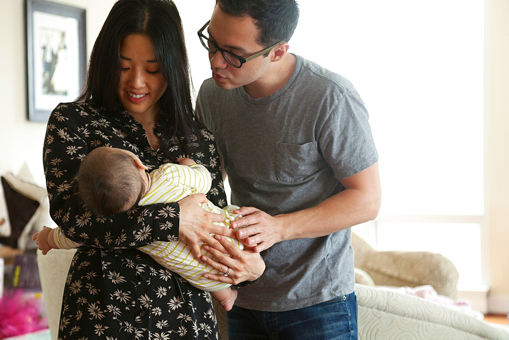 Parents holding baby girl