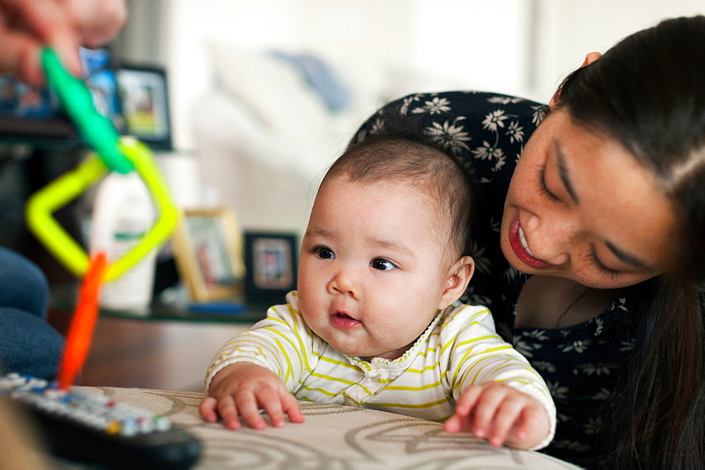 Close up of parents playing with baby daughter