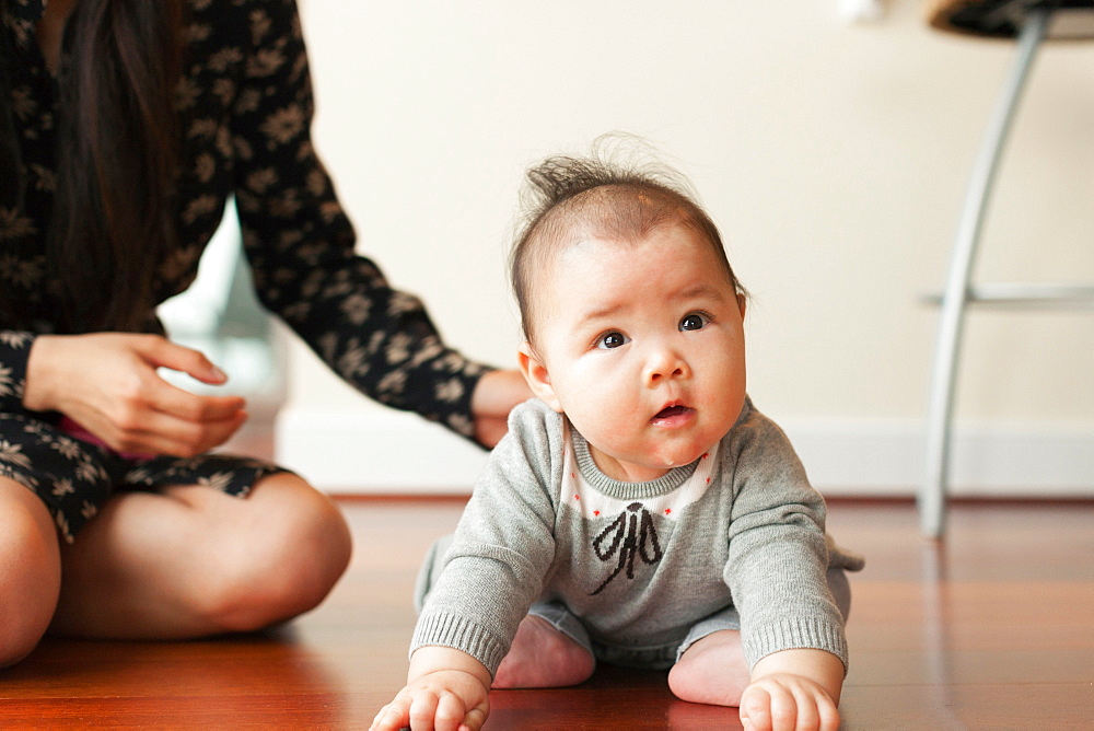 Baby girl sitting on floor