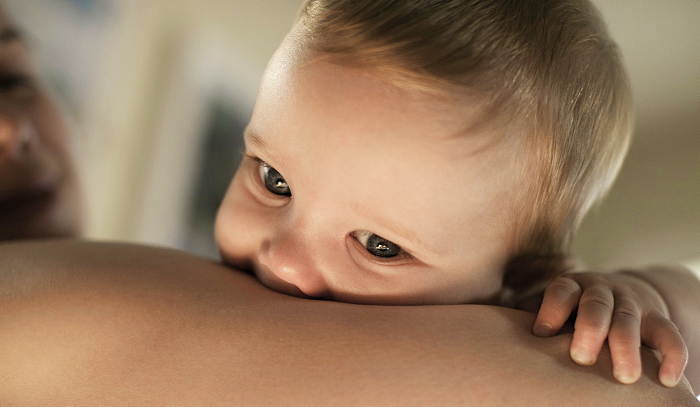 Baby boy cradled in mother's arm