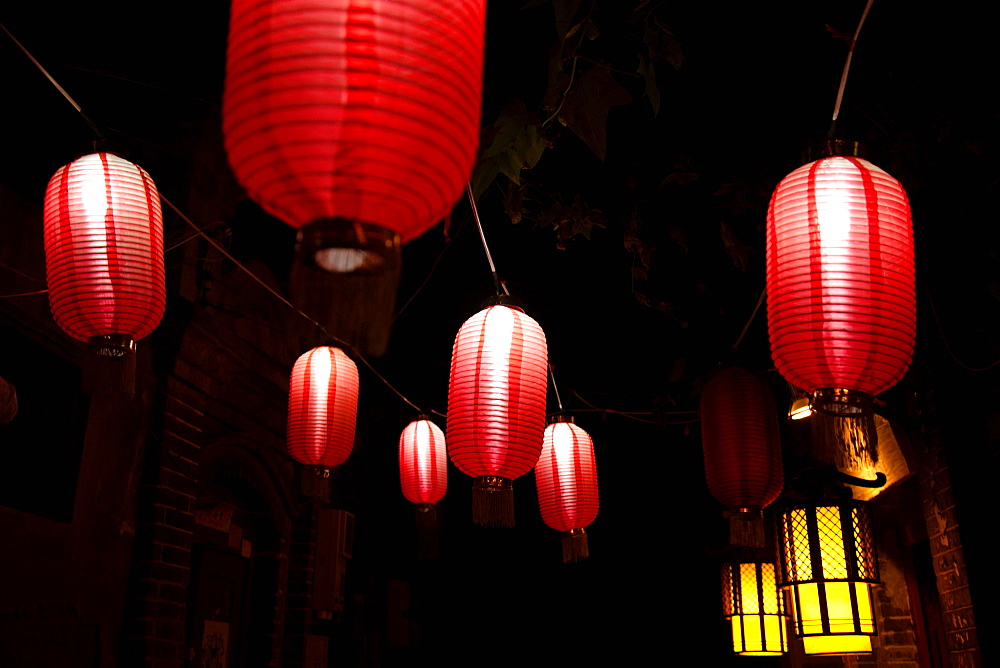 Paper lanterns on city street at night