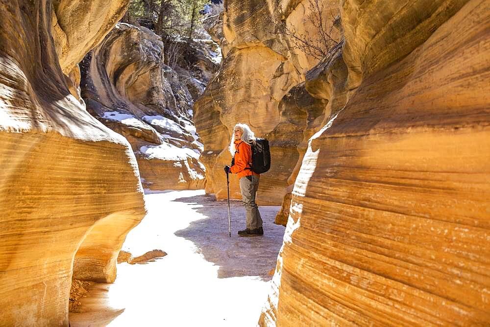 USA, Utah, Escalante, Woman hiking in slot canyon in Grand Staircase-Escalante National Monument