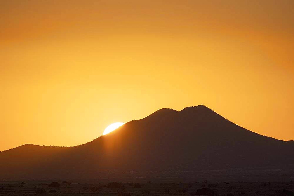 USA, New Mexico, Santa Fe, Sun setting over Cerrillos Hills State Park