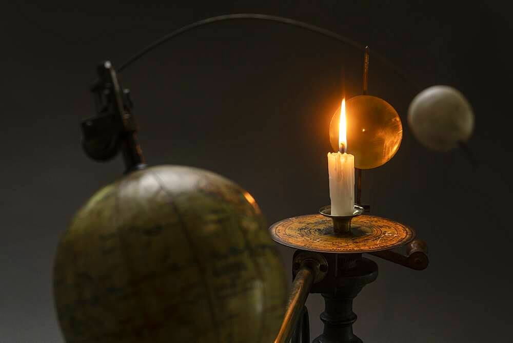 Antique globe and candle solar system model