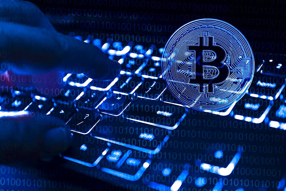 Fingers at computer keyboard and bitcoin, cgi