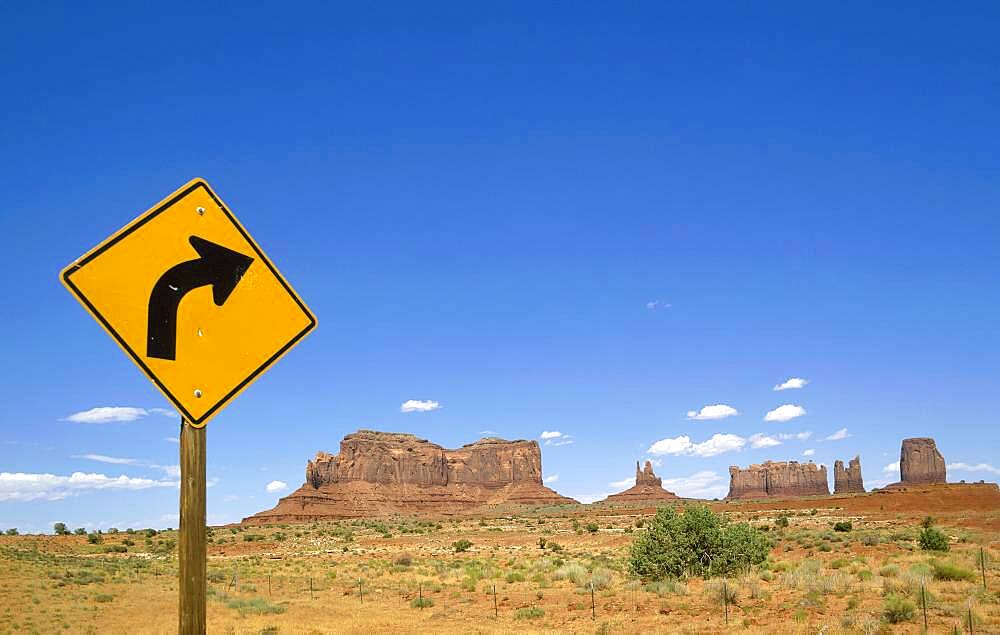 Arizona, Monument Valley Tribal Park, Road sign in Monument Valley with West and East Mitten Buttes in background