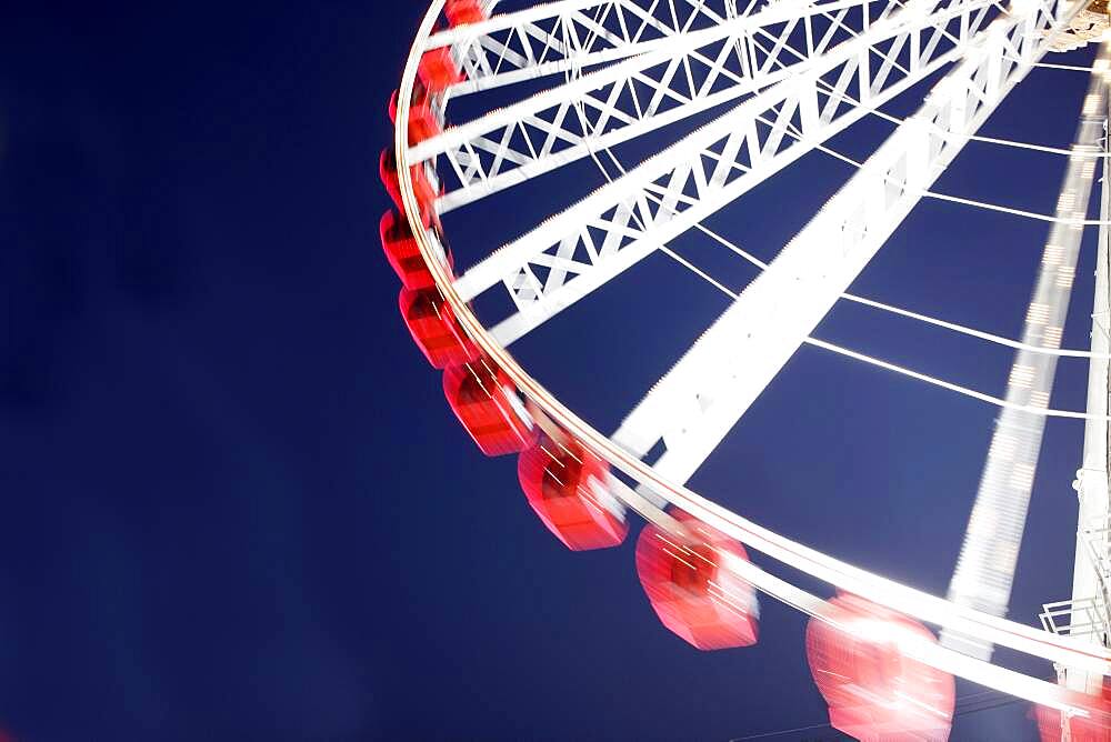 Low angle view of spinning ferris wheel