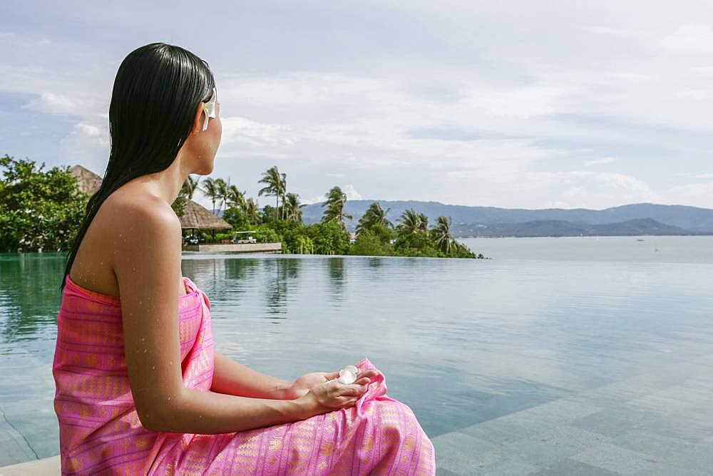 Thailand, Koh Samui Island, Woman looking at calm tropical landscape