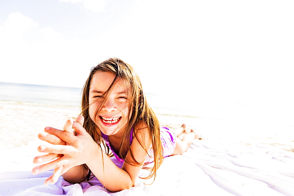 Portrait of happy girl (6-7) sunbathing, Jupiter, Florida