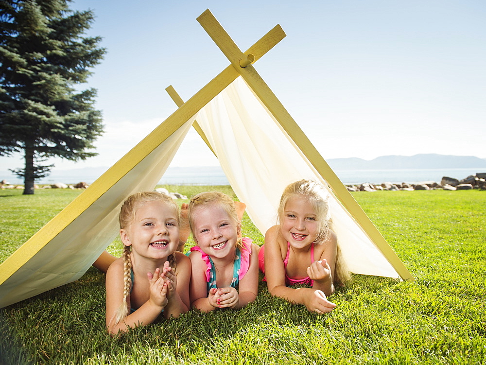 Three girls (2-3, 4-5) playing in tent, Garden City, Utah