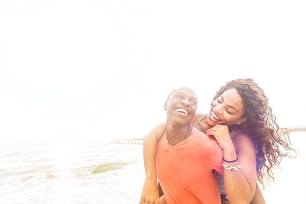 Young couple playing on beach, Jupiter, Florida