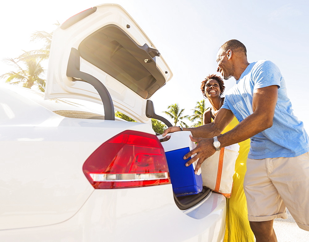 Mature couple loading car trunk, Jupiter, Florida