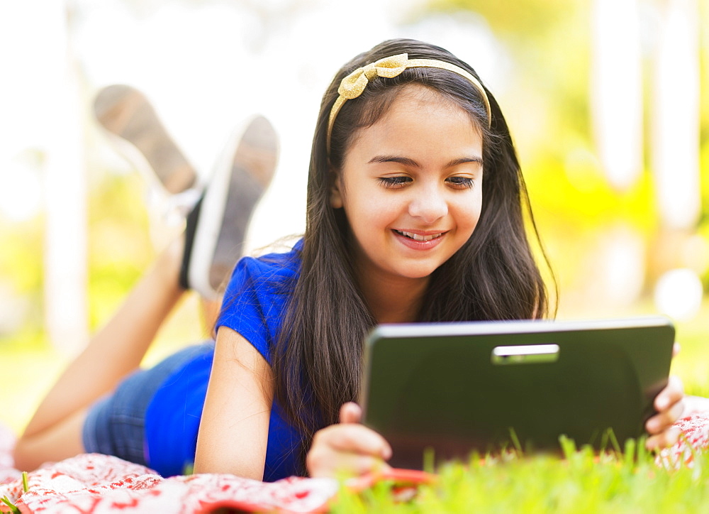girl ( 8-9) using digital tablet 