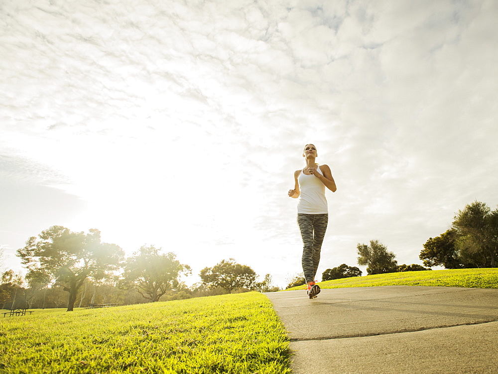 Woman running in park, Irvine, California