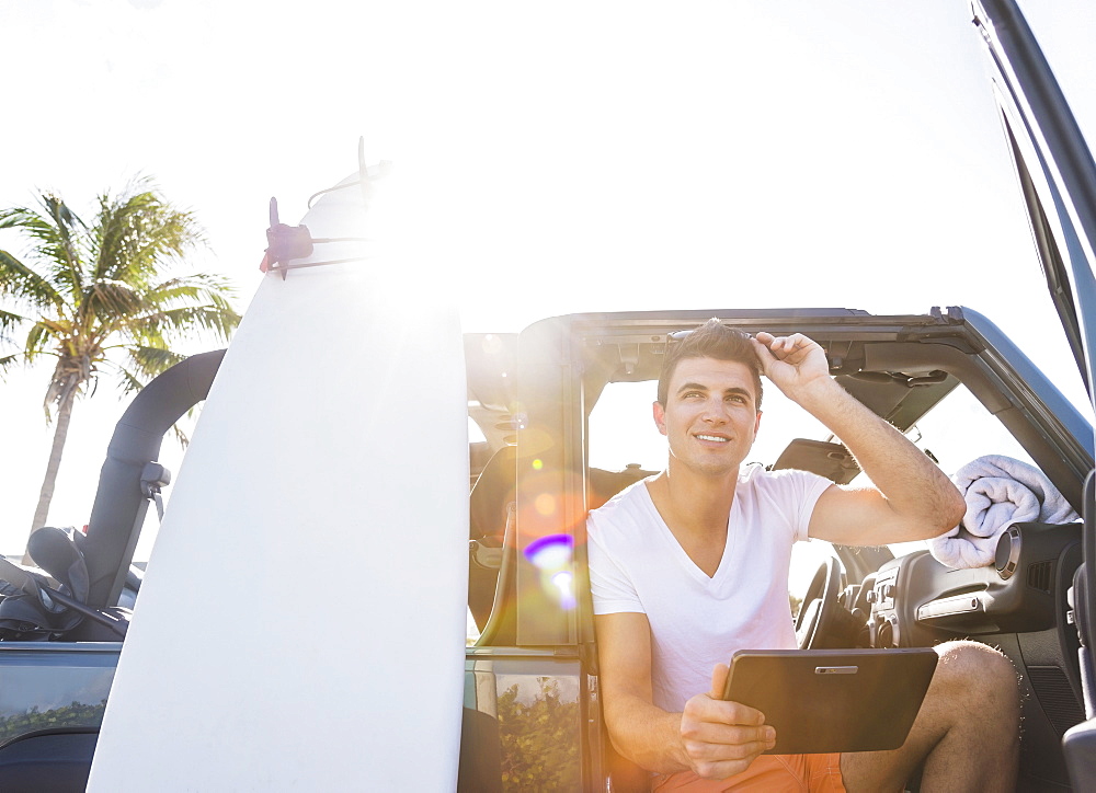 Young man using digital tablet, Jupiter, Florida, USA