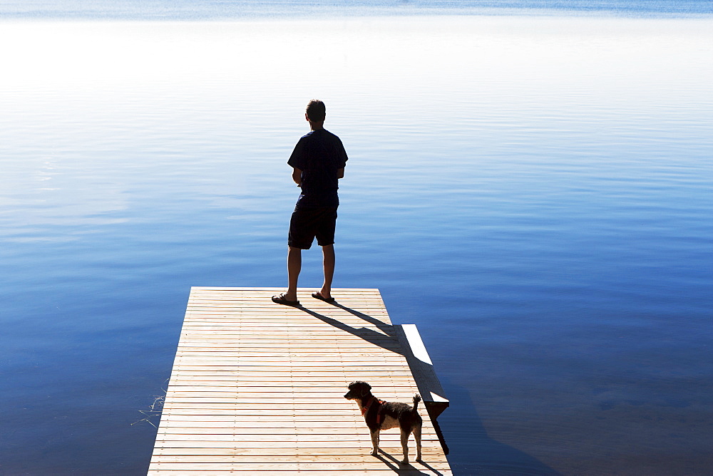 Rear view of man on jetty looking at view, USA, New York State, Wurtsboro