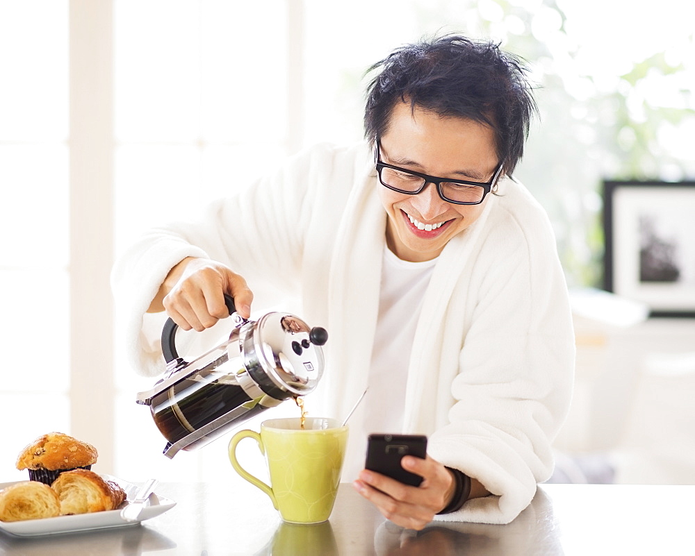 Teenage boy (16-17) eating breakfast