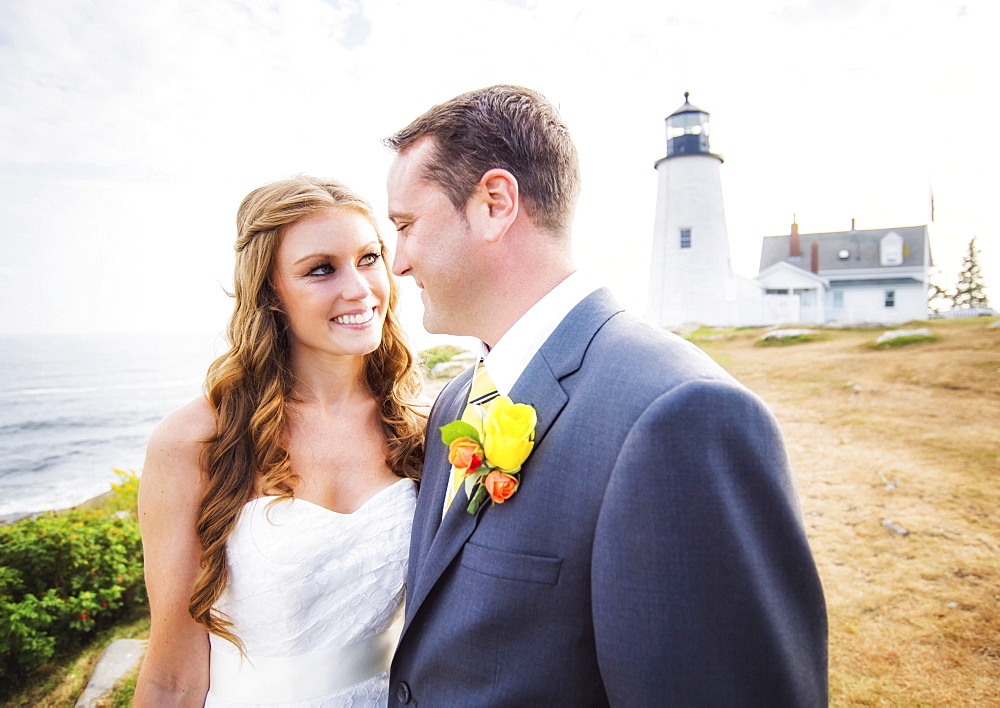 Portrait of married couple, lighthouse in background, USA, Maine, Bristol 