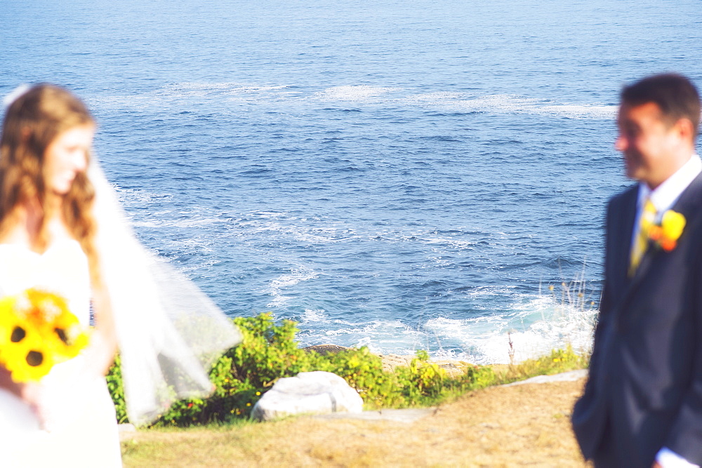 Bride and groom looking at each other, USA, Maine, Bristol 