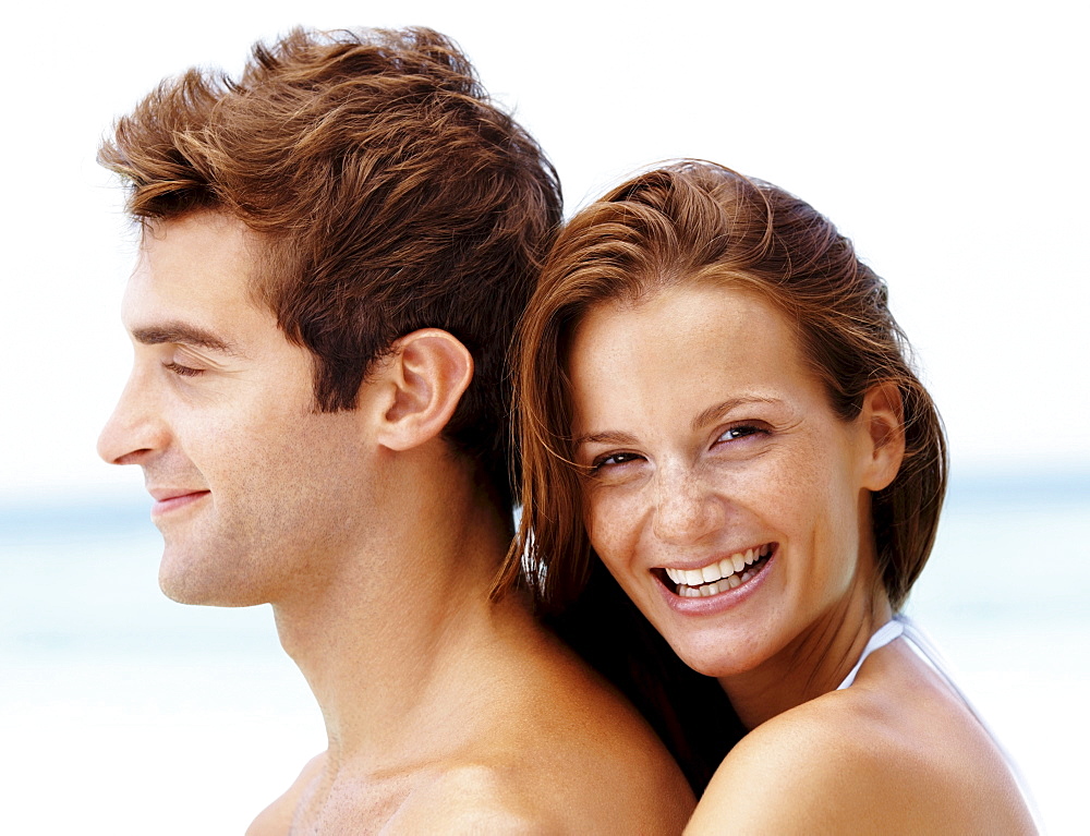 Young attractive couple enjoying summer holiday on beach