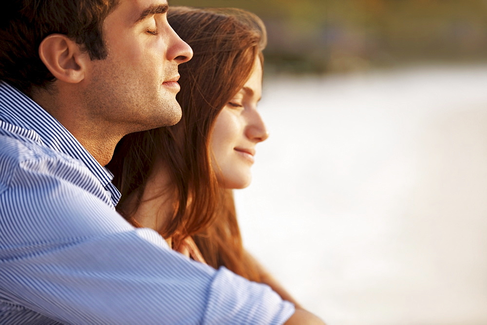 Portrait of couple hugging on beach