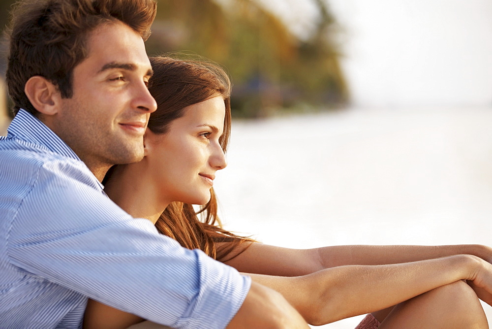 Portrait of couple hugging on beach