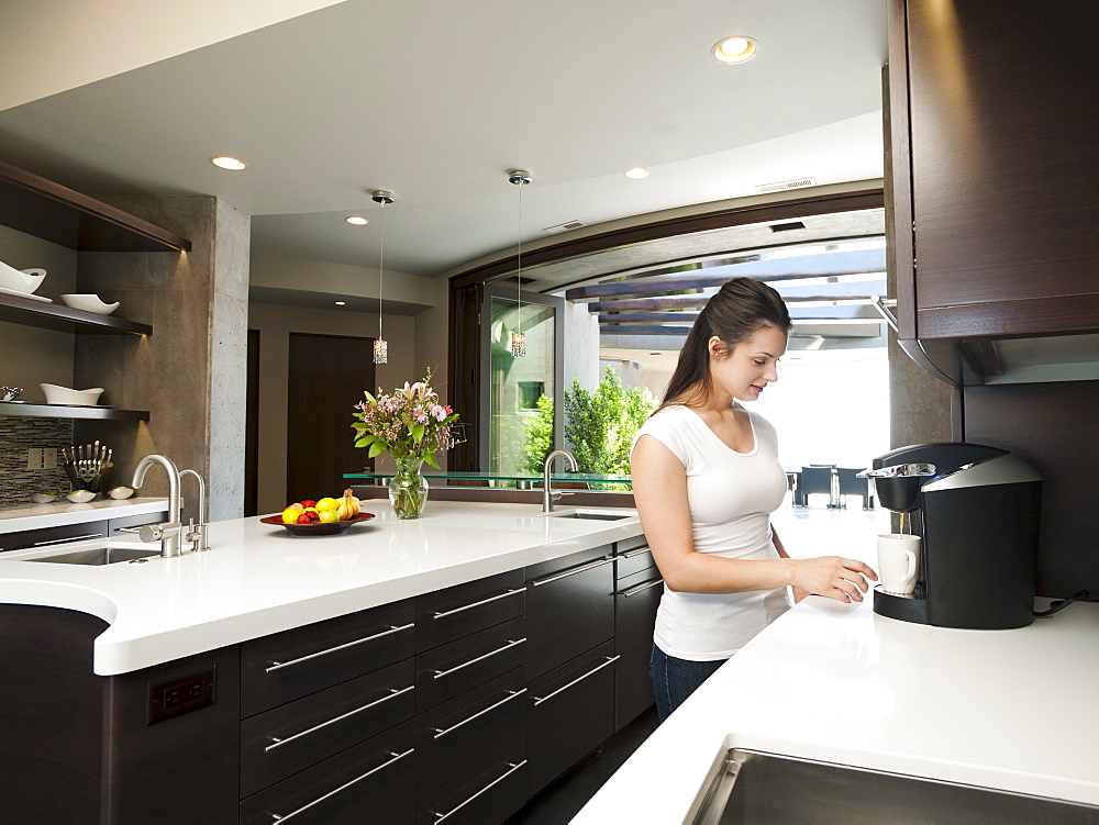 Young woman making morning coffee