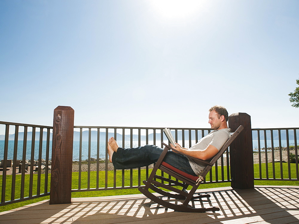 Mid-adult man relaxing on rocking chair, USA, Utah, Garden City