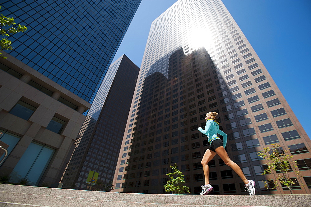 USA, California, Los Angeles, Young woman running in city, USA, California, Los Angeles