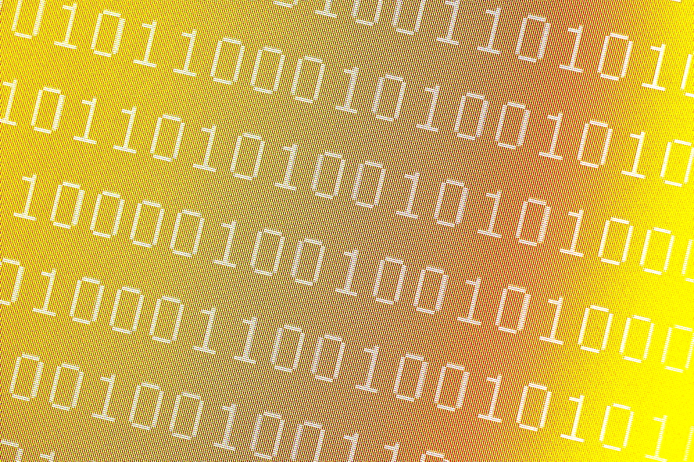 Binary numbers on pixelated yellow computer screen