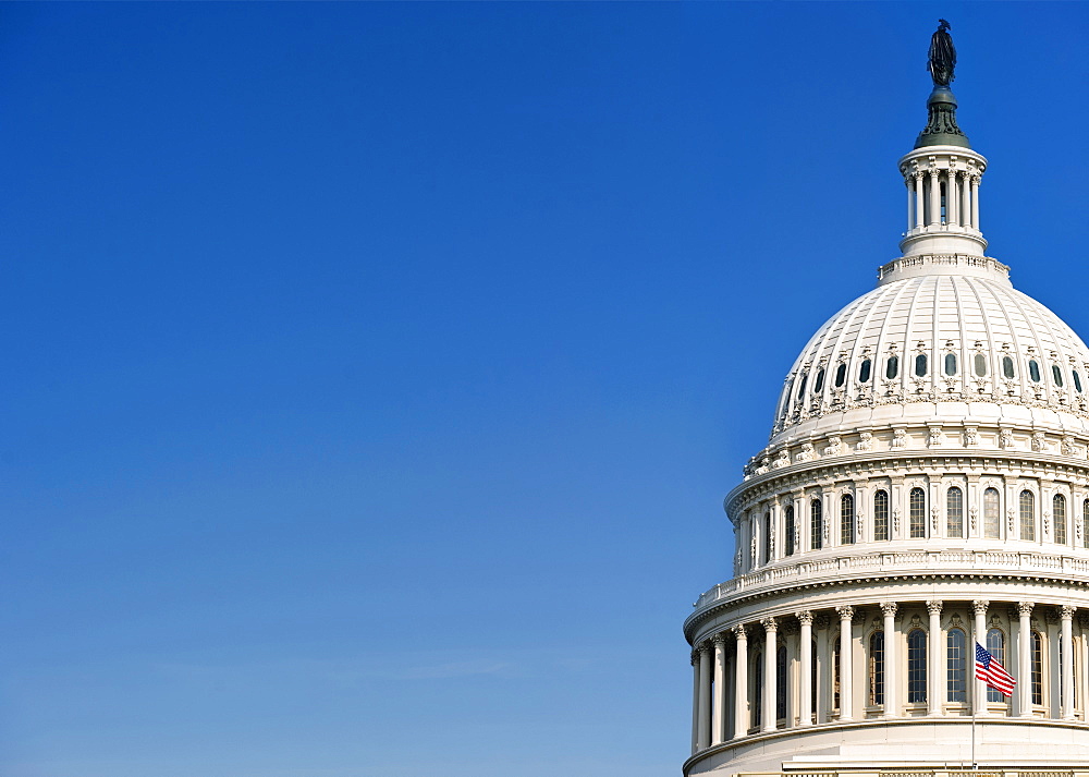 USA, Washington D.C., USA Capital building with flag against blue sky