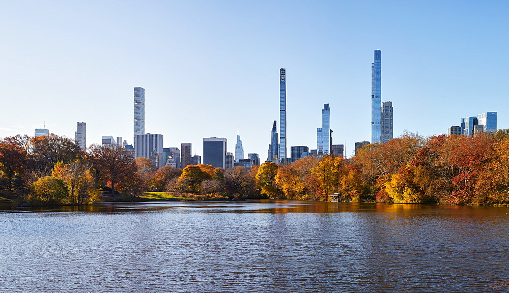 USA, New York, New York City, Midtown Manhattan skyscrapers seen across pond in Central Park