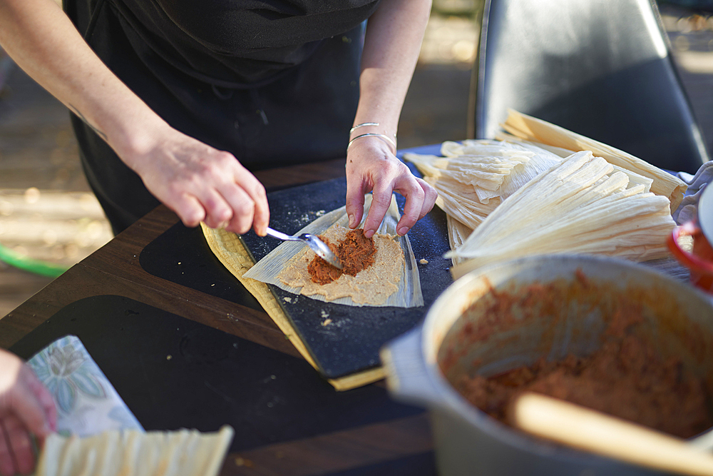 Person preparing tamales, close up