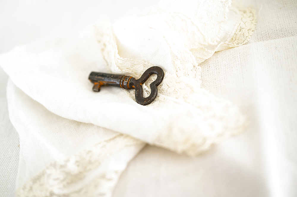 Heart shaped key on decorative white cloth