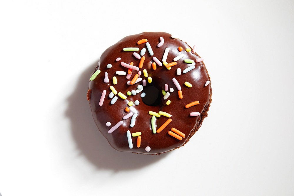 Overhead view of donut with chocolate icing and sprinkles