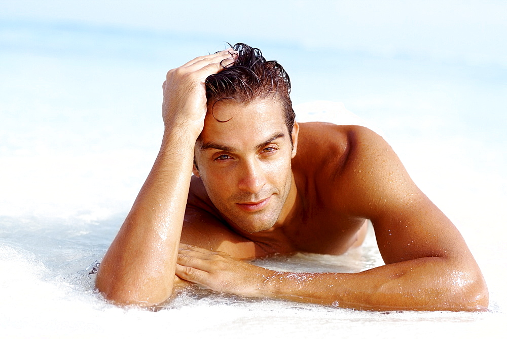 Portrait of attractive young man relaxing on beach