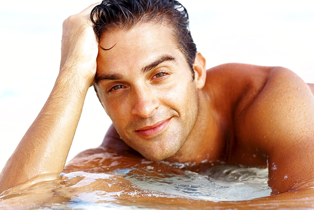 Portrait of attractive young man relaxing on beach